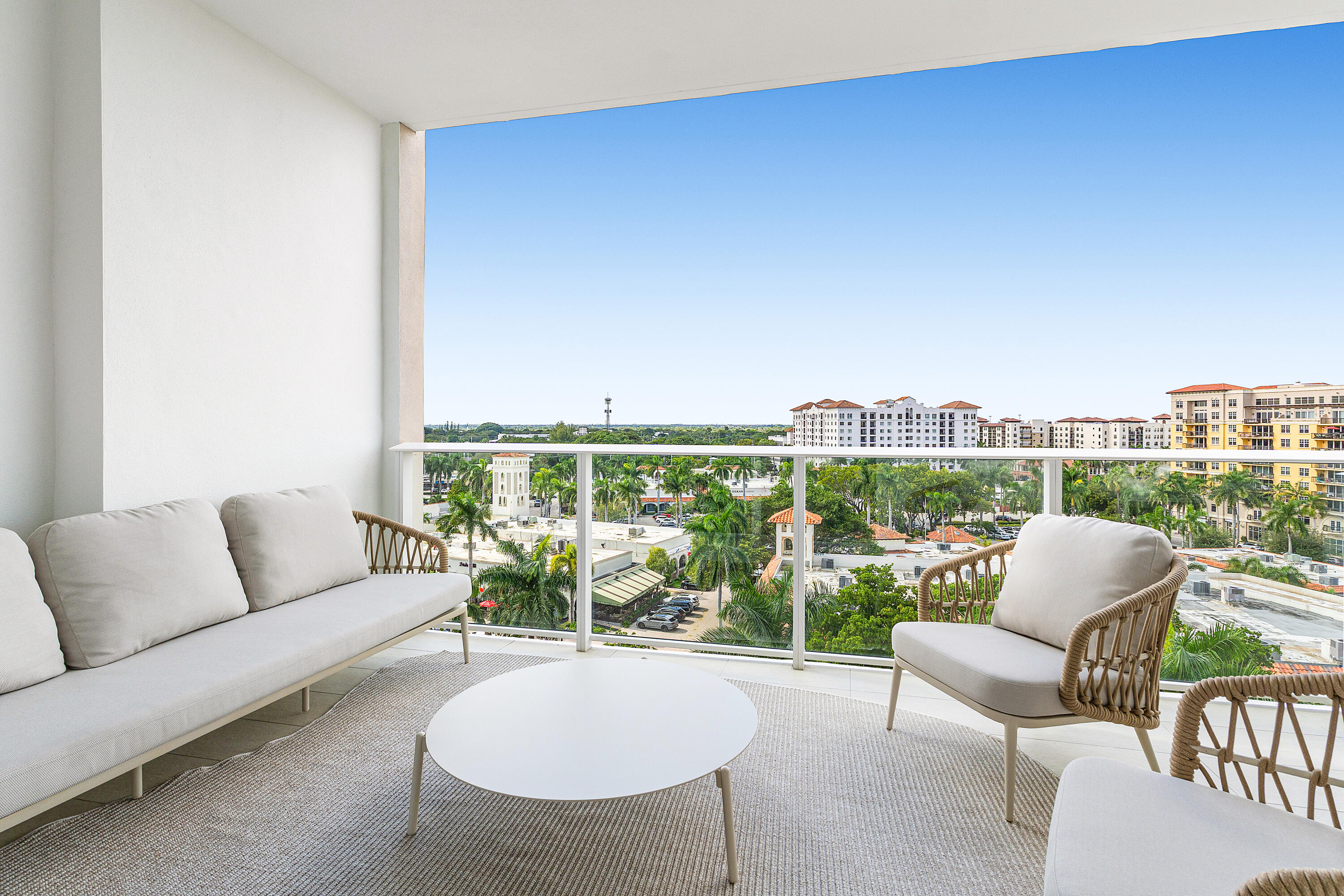220 Southeast Mizner Boulevard, Unit 810 Boca Raton, FL 33432 - Photo 10 of 39 a living room with furniture a table and a floor to ceiling window