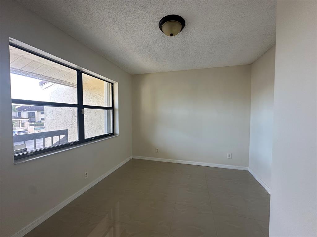 22415 Southwest 61st Way, Unit 202 Boca Raton, FL 33428 - Photo 5 of 14 an empty room with a window