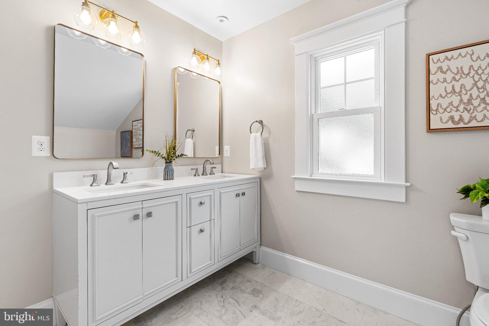 106 Sycamore Road Linthicum Heights, MD 21090 - Photo 39 of 51 a bathroom with a double vanity sink and a mirror