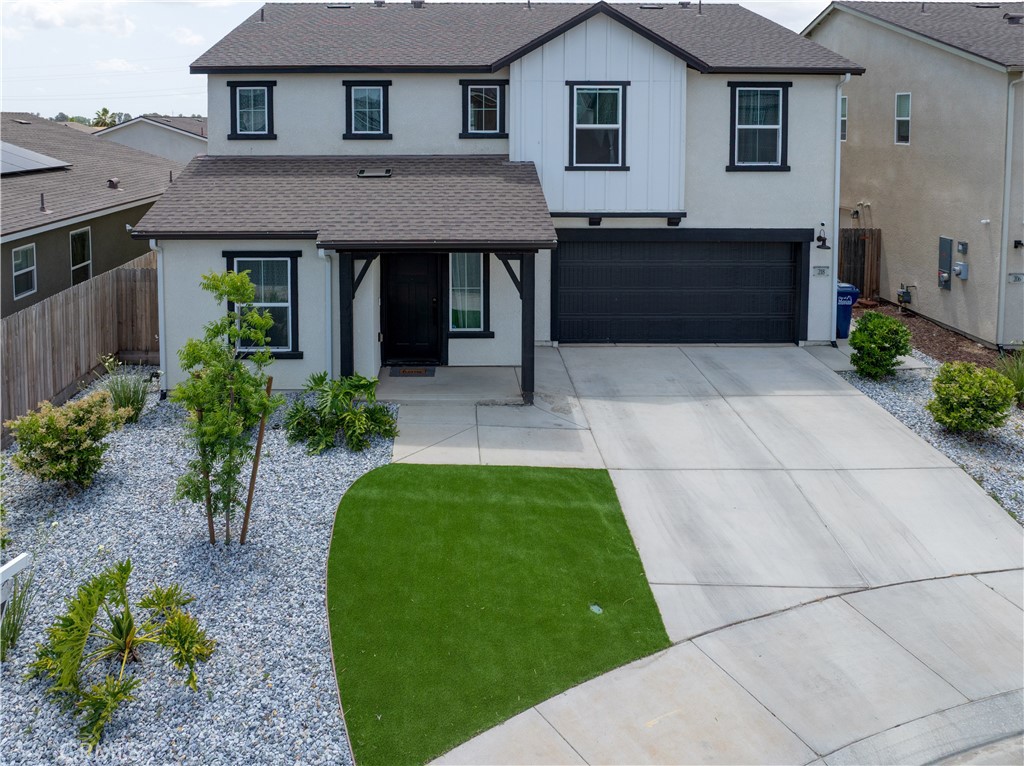 a front view of a house with a garden