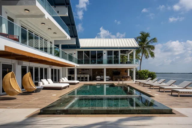 a front view of a house with yard and balcony
