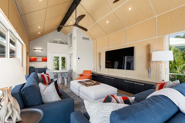 a living room with a couch and a potted plant