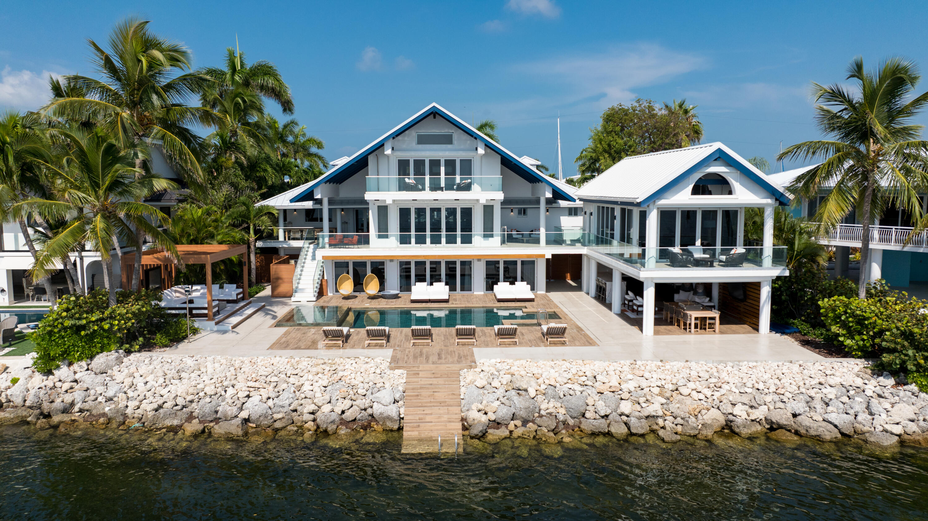 555 Ocean Cay Key Largo, FL 33037 - Photo 3 of 46 a front view of a house with a small yard and potted plants