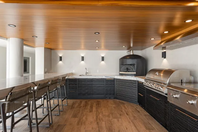 a kitchen with stainless steel appliances granite countertop a stove and cabinets