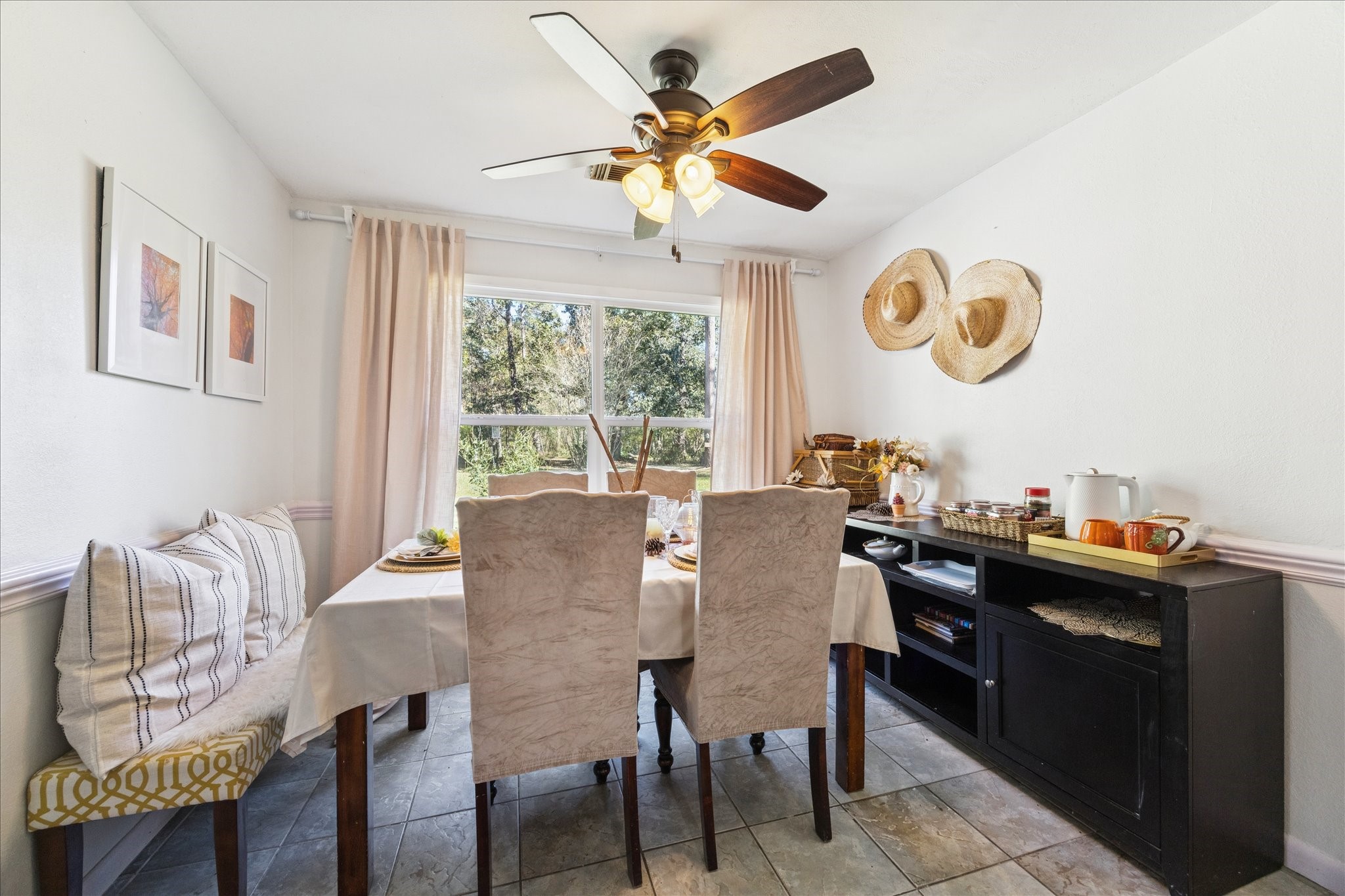 6 B Davidson Lane Huffman, TX 77336 - Photo 8 of 20 Bright dining area with a large window, offering natural light and views of greenery. Decorated with neutral tones and charming accents.