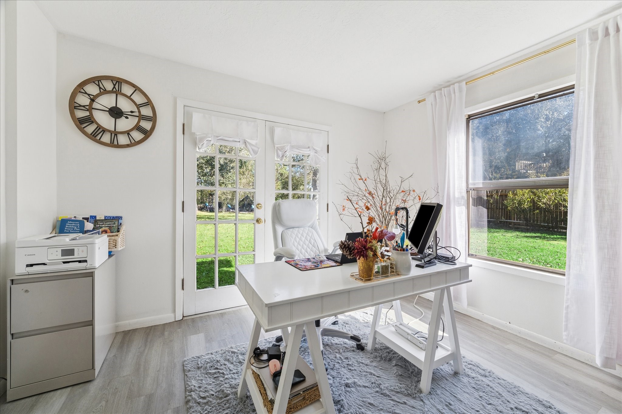 6 B Davidson Lane Huffman, TX 77336 - Photo 10 of 20 Bright and airy home office with large windows and glass french doors offering a view of the lush backyard. This is office space created in the primary. You can make it into anything you want.