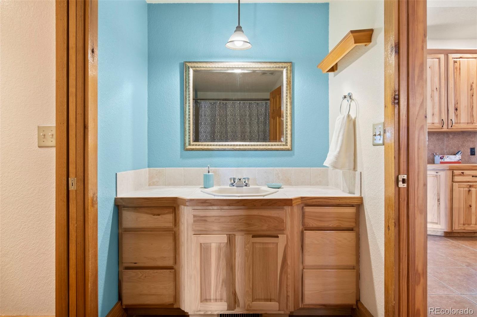 412 Evergreen Road Black Hawk, CO 80422 - Photo 10 of 48 a bathroom with a sink a vanity and a mirror