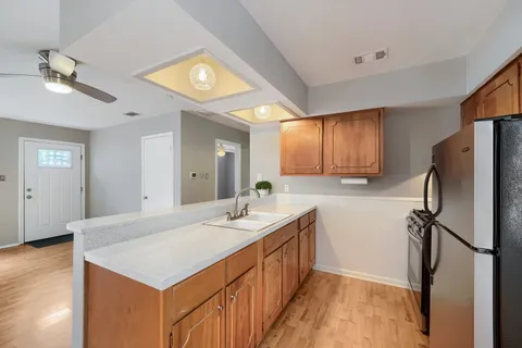 a kitchen with a refrigerator and a sink