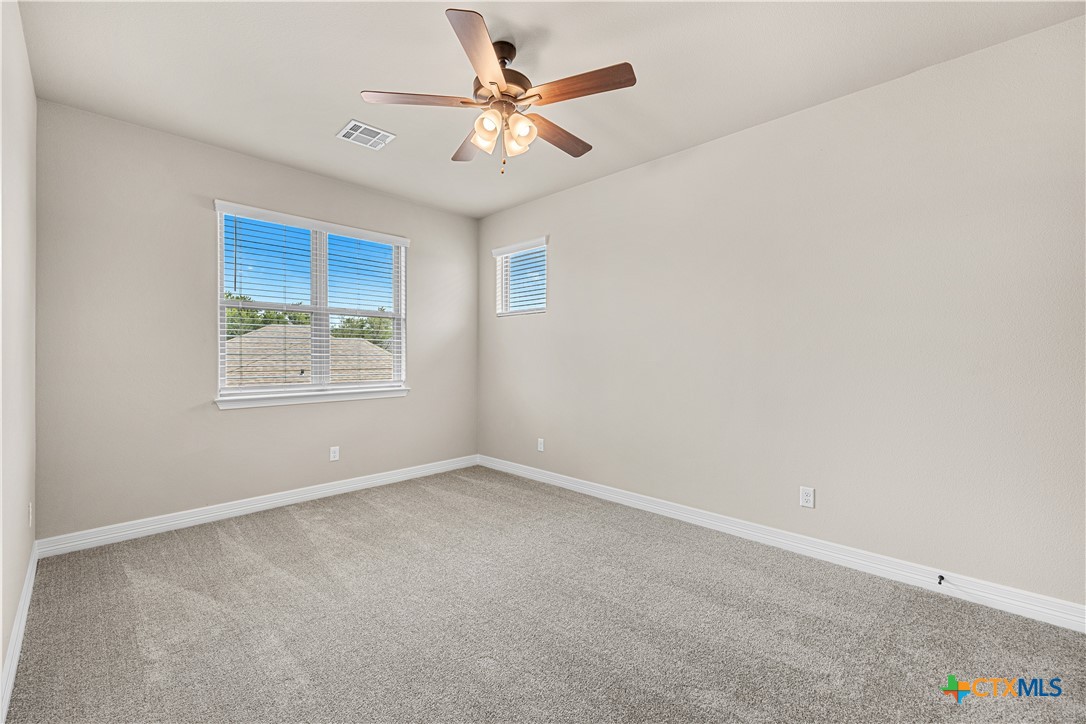 2136 Oak Draw Court Belton, TX 76513 - Photo 30 of 46 an empty room with a window and a ceiling fan