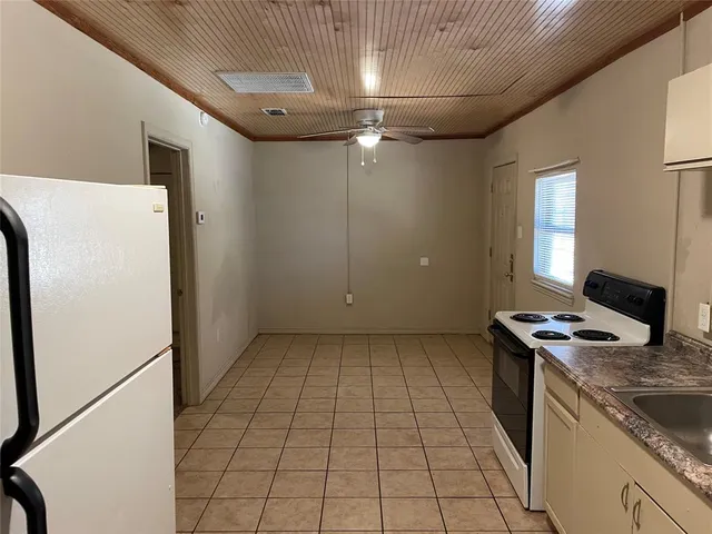 a kitchen with a sink and a refrigerator