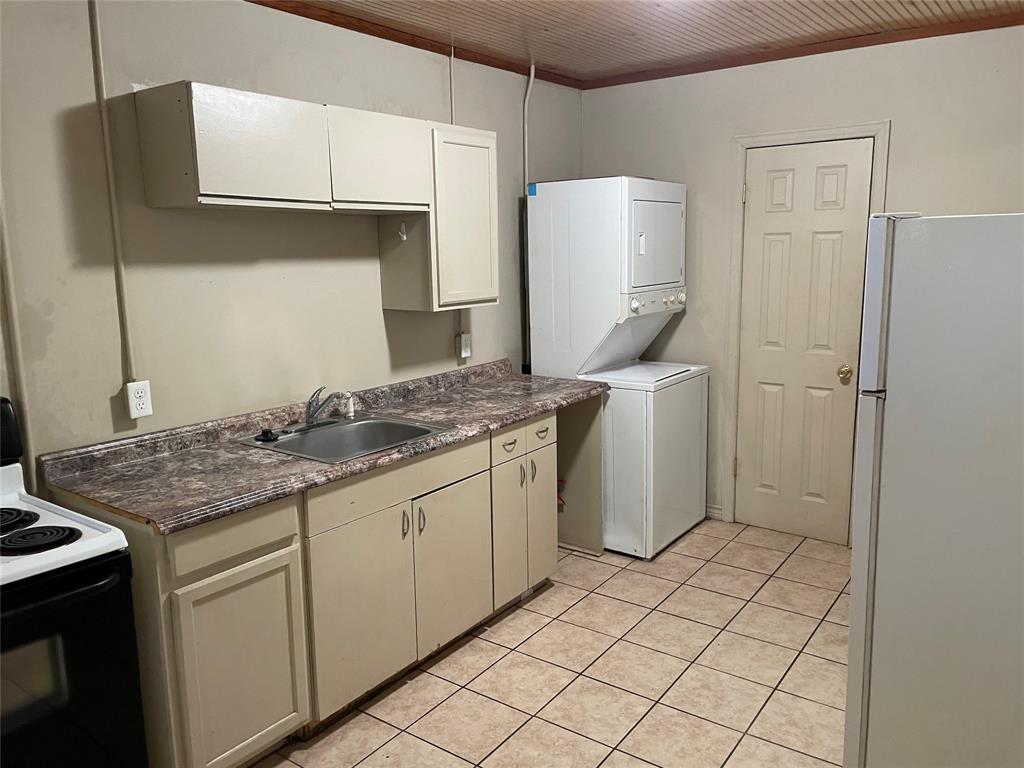 2826 Pine Street Abilene, TX 79601 - Photo 6 of 10 a kitchen with a sink and a refrigerator