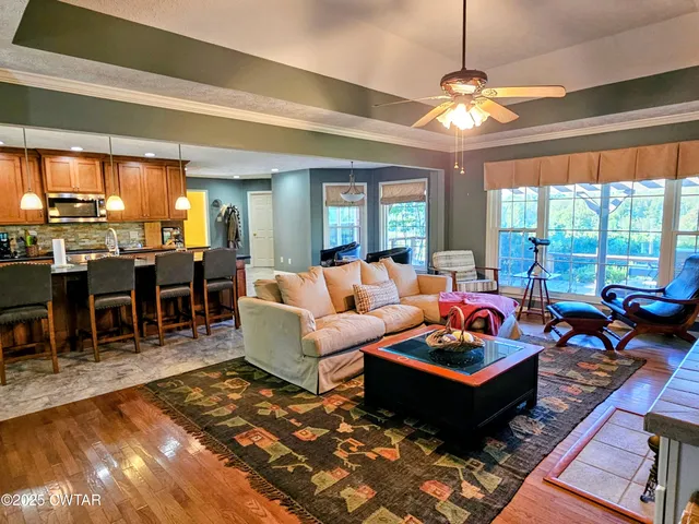 a living room with lots of furniture and a chandelier