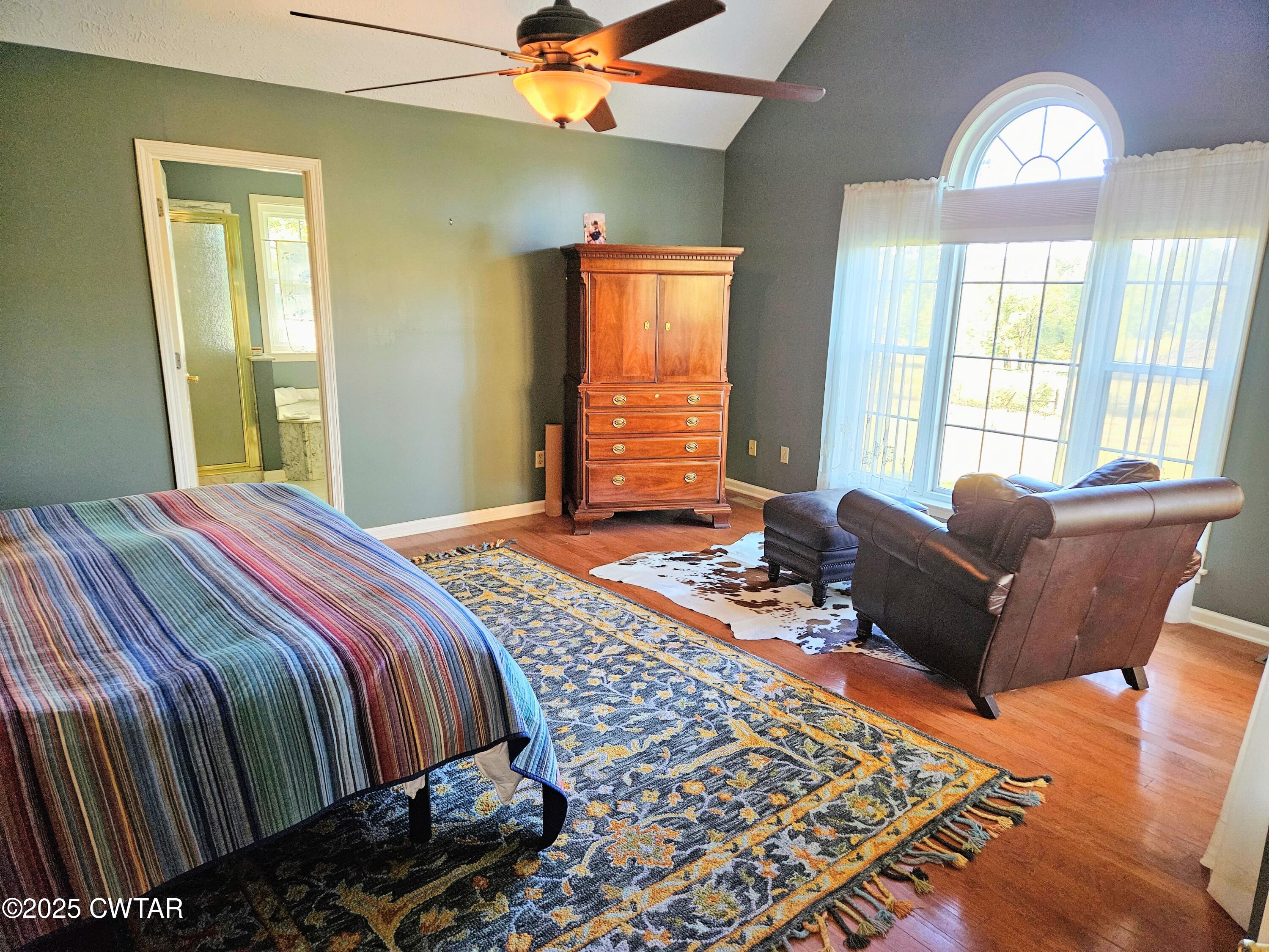 125 Hurts Chapel Road Jackson, TN 38301 - Photo 15 of 50 a bedroom with a bed and wooden floor