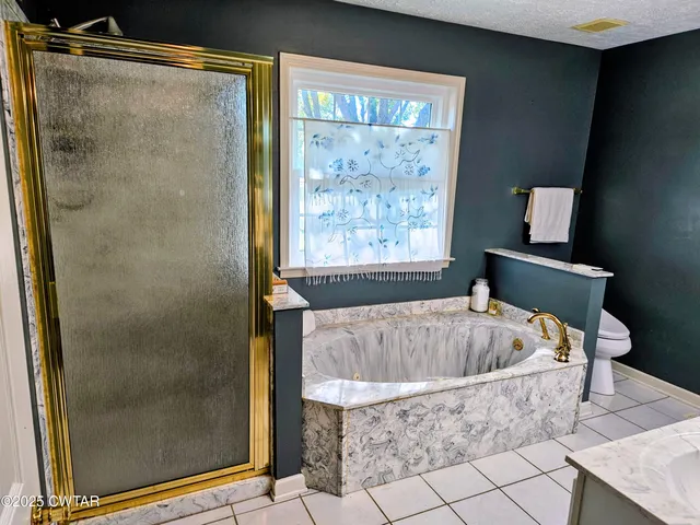a bath tub sitting in a bathroom next to a window