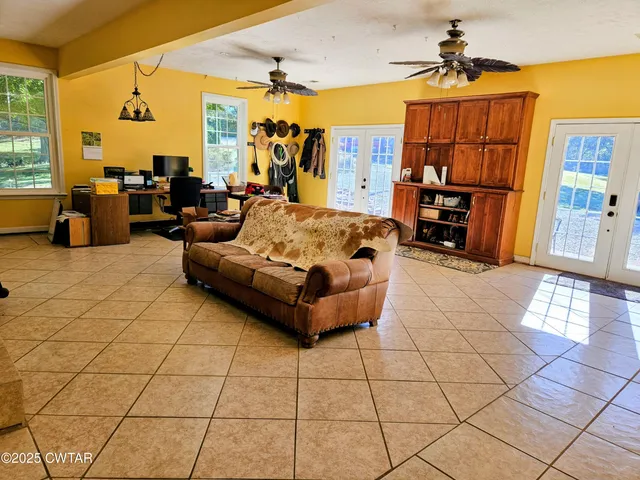 a living room with furniture and a chandelier