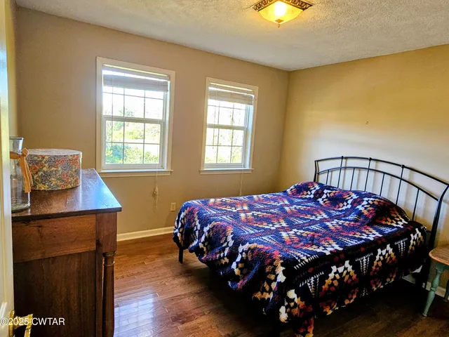 a bedroom with furniture and a window