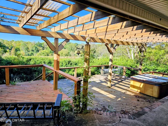 a view of a backyard with table and chairs under an umbrella