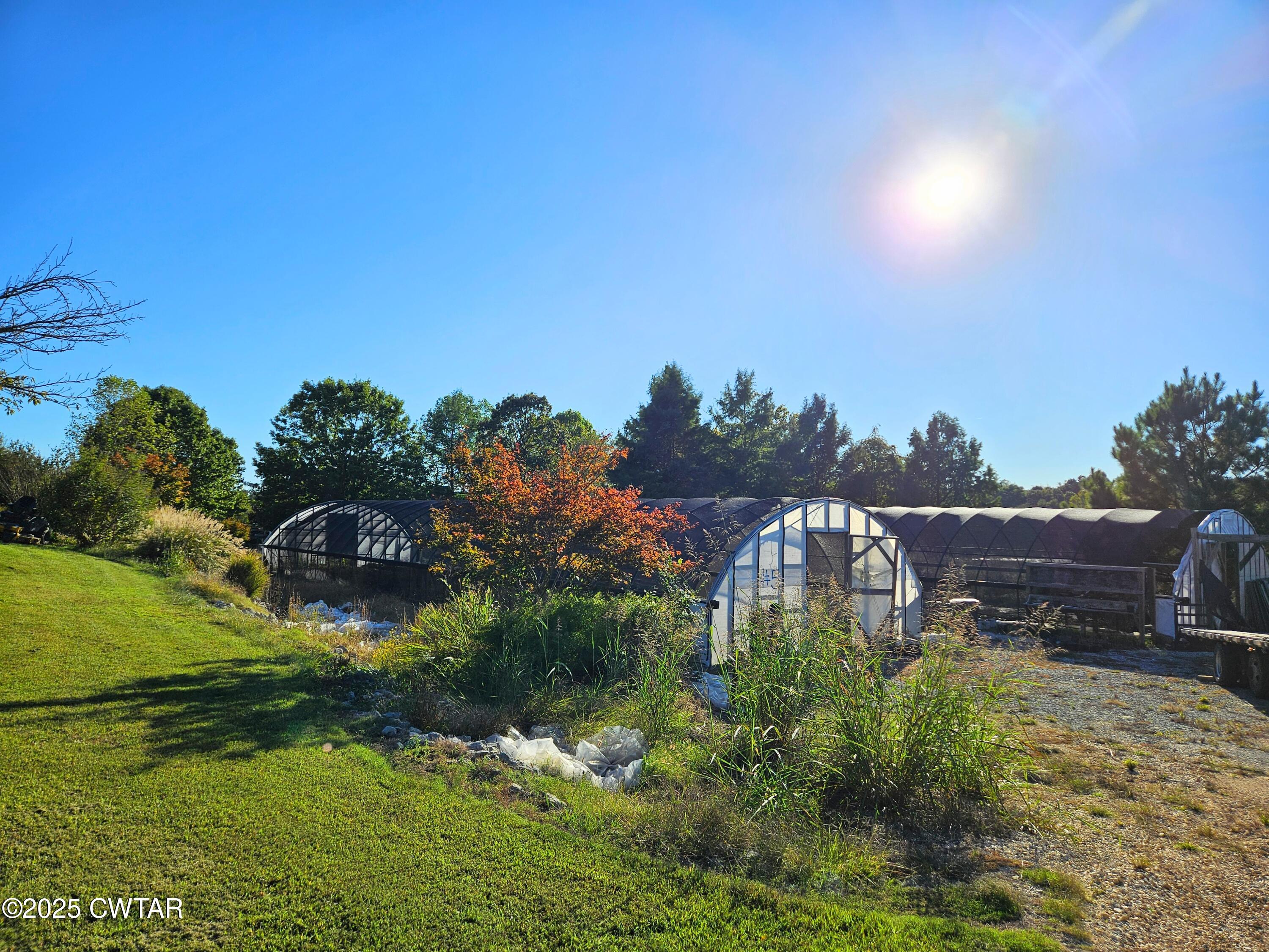 125 Hurts Chapel Road Jackson, TN 38301 - Photo 44 of 50 a view of a garden with a building in the background