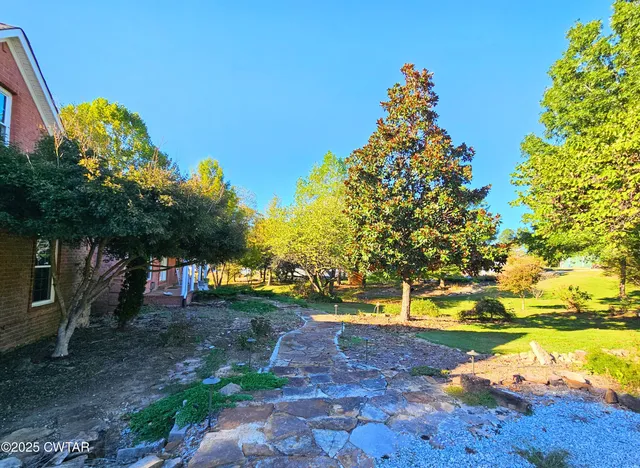a backyard of a house with yard and outdoor seating