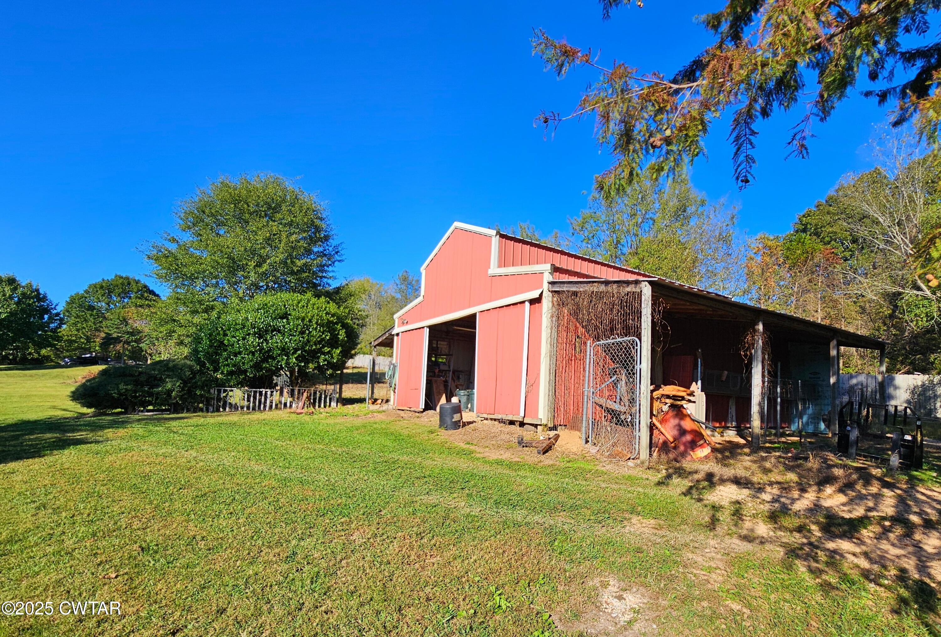 125 Hurts Chapel Road Jackson, TN 38301 - Photo 49 of 50 a backyard of a house with yard and outdoor seating