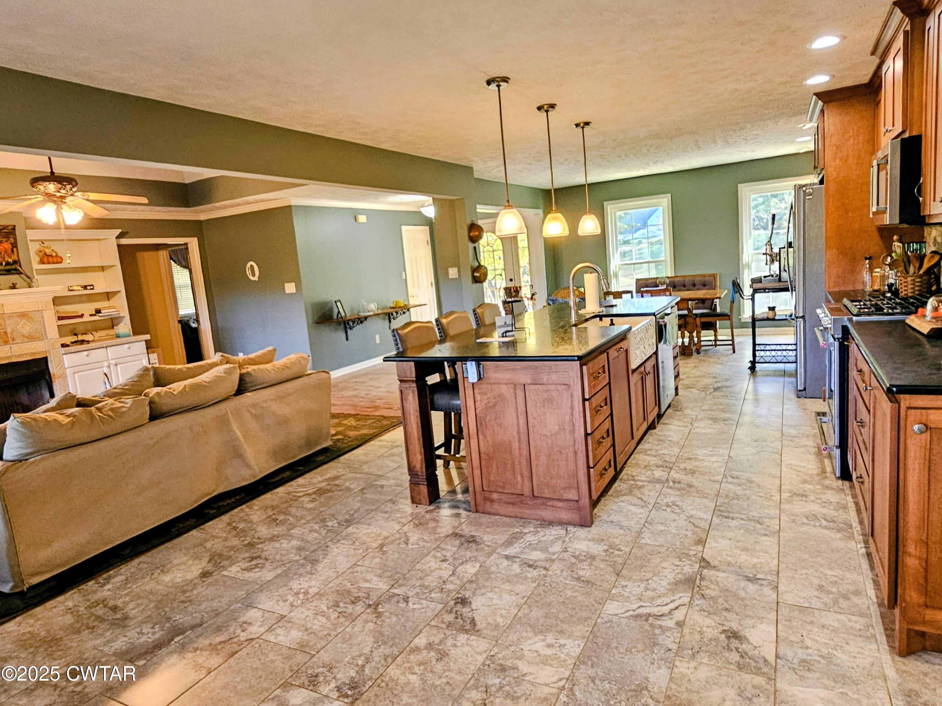 125 Hurts Chapel Road Jackson, TN 38301 - Photo 6 of 50 a living room with furniture a chandelier and a dining table