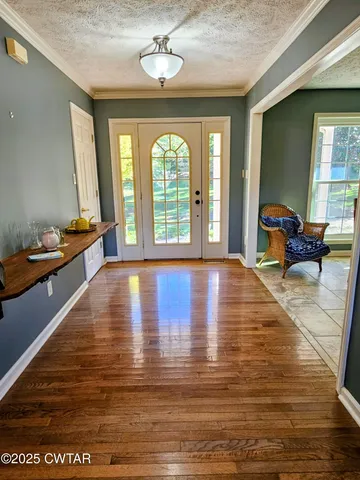 a living room with fireplace furniture and a large window