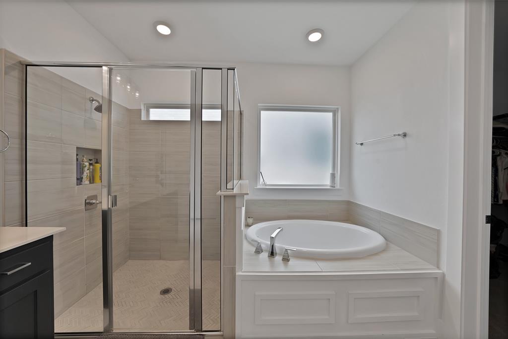 1010 Adair Road Prosper, TX 75078 - Photo 16 of 39 a bathroom with a shower a mirror and a sink