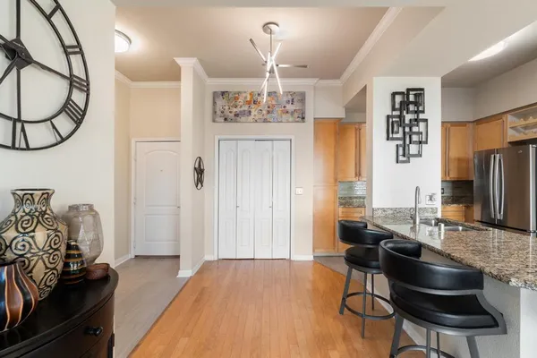 a living room with furniture a dining table and a chandelier