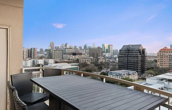a view of a roof deck with table and chairs