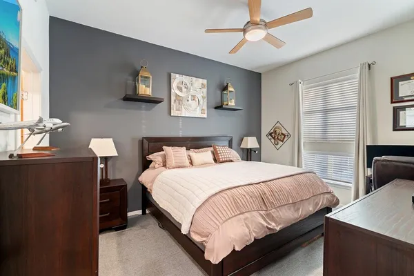 a bedroom with a bed and a chandelier