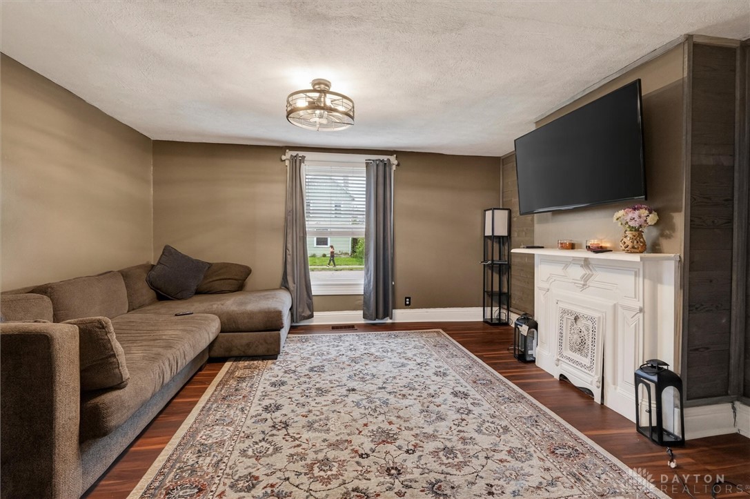 1726 Morgan Street Springfield, OH 45503 - Photo 11 of 30 This inviting living room showcases rich wood flooring and a classic decorative fireplace.
