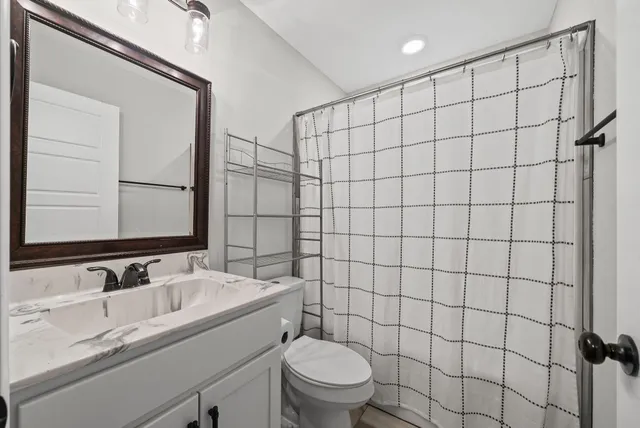 a bedroom with a bed a desk and chair with the bookshelf