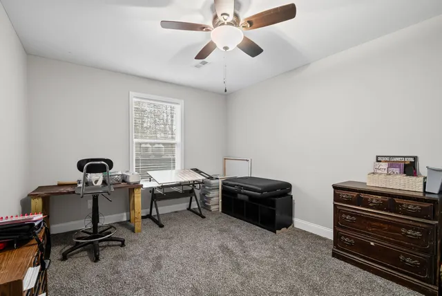 a view of room with window and a ceiling fan