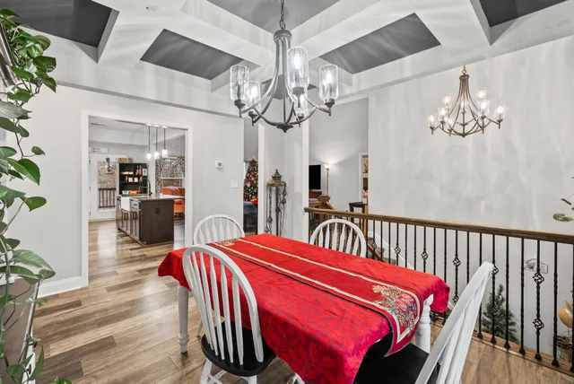 a kitchen with kitchen island granite countertop a sink and dishwasher a fireplace with wooden floor