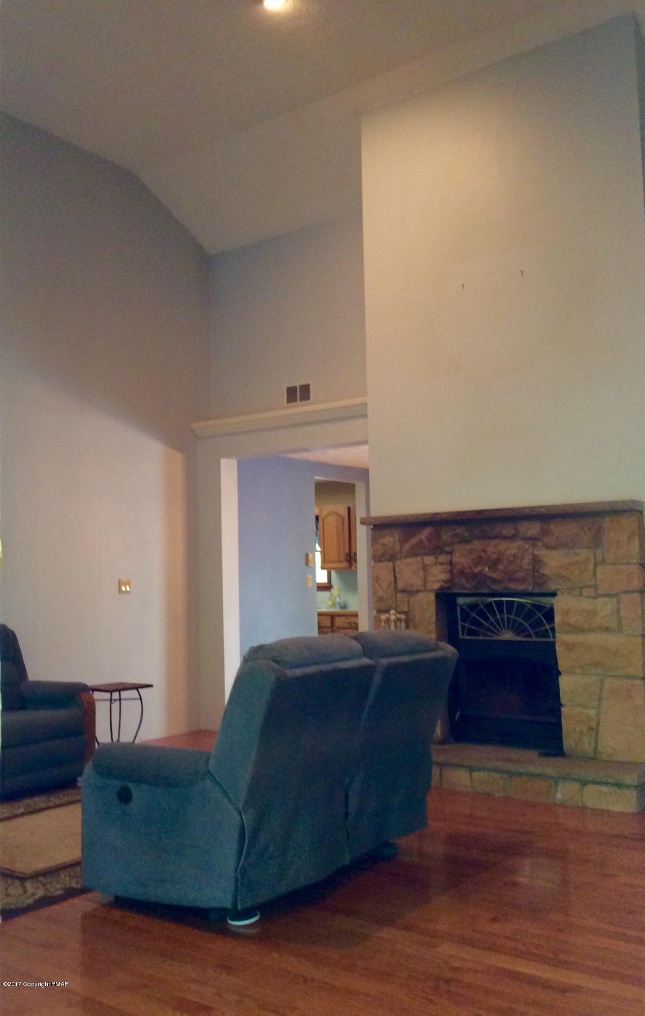 2125 Laurel Ridge Road East Stroudsburg, PA 18302 - Photo 11 of 54 a living room with furniture and a fireplace