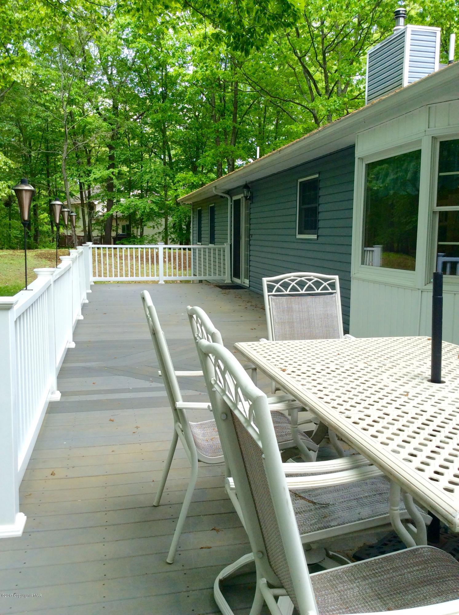 2125 Laurel Ridge Road East Stroudsburg, PA 18302 - Photo 44 of 54 a view of a patio with table and chairs with wooden floor and fence