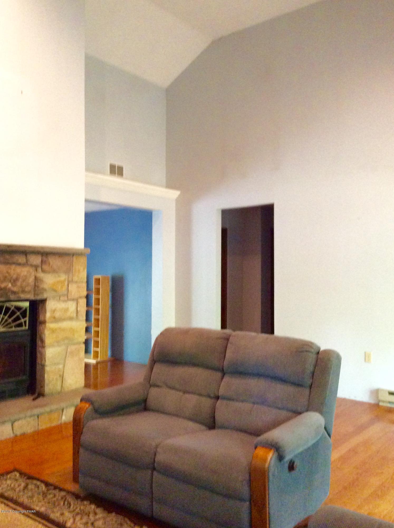 2125 Laurel Ridge Road East Stroudsburg, PA 18302 - Photo 8 of 54 a living room with furniture and a fireplace