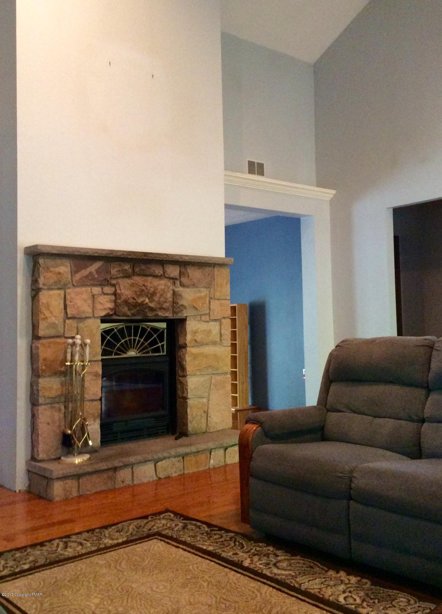 2125 Laurel Ridge Road East Stroudsburg, PA 18302 - Photo 9 of 54 a living room with furniture a flat screen tv and a fireplace