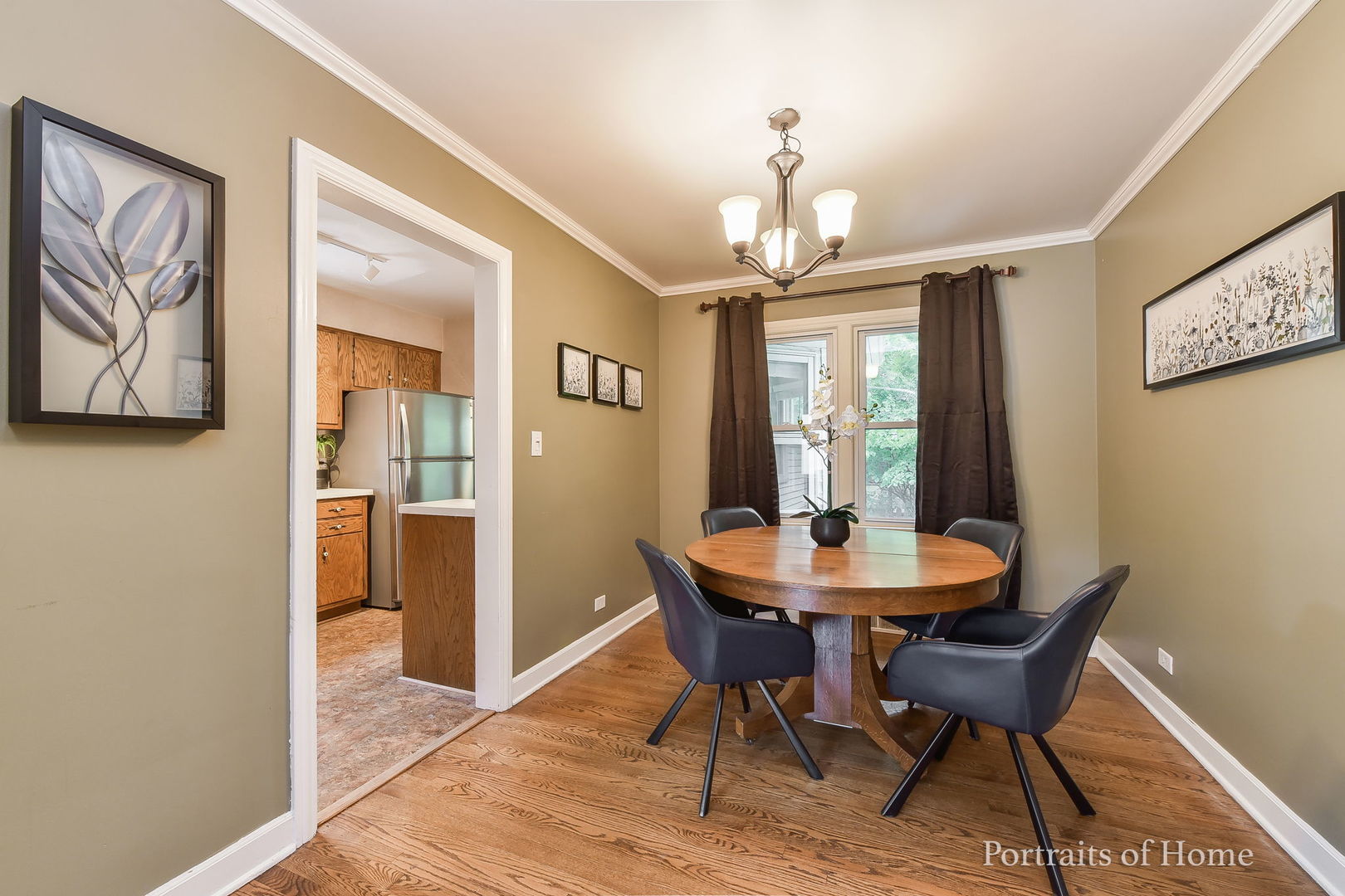 602 North President Street Wheaton, IL 60187 - Photo 4 of 16 a dining room with furniture a chandelier and wooden floor