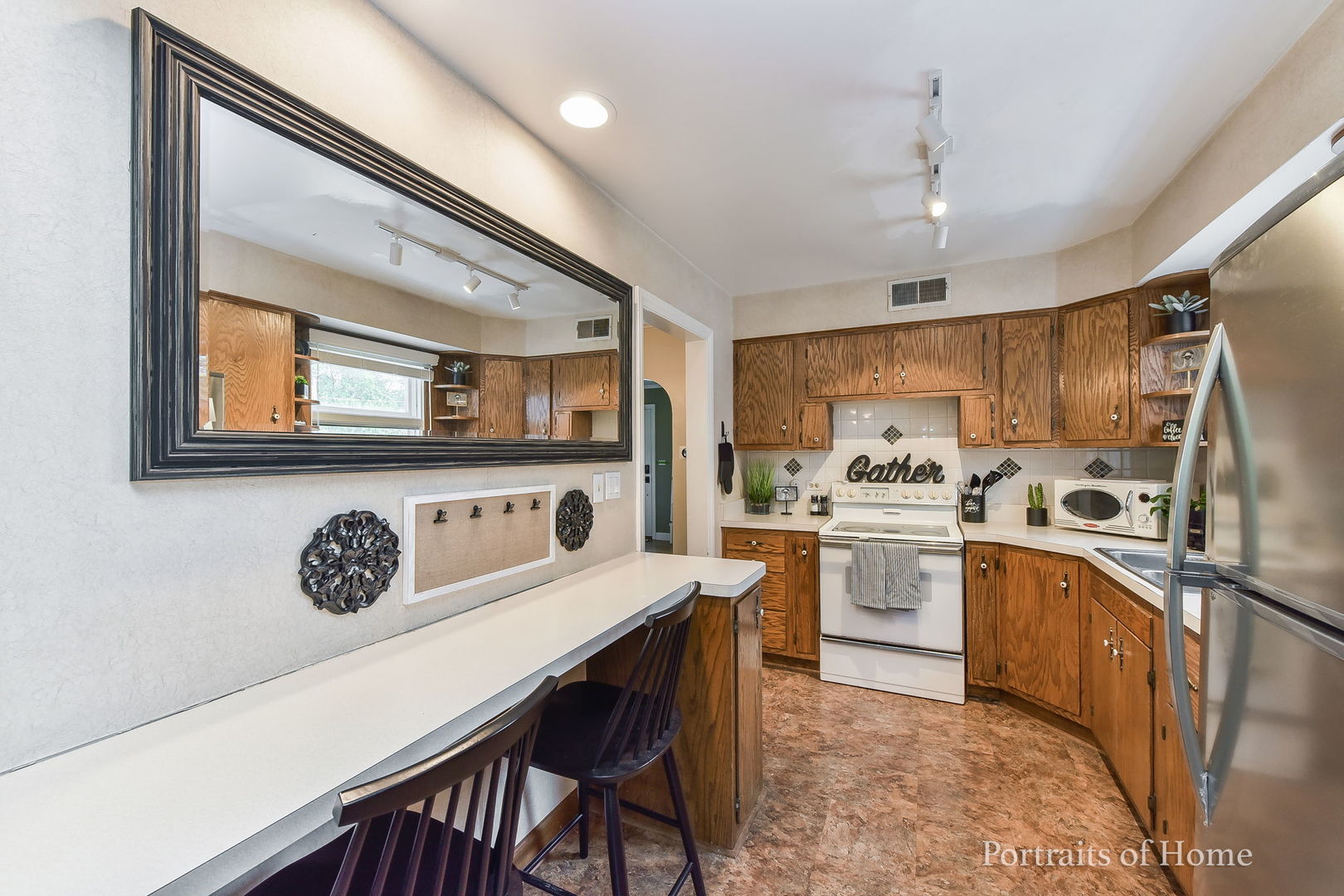 602 North President Street Wheaton, IL 60187 - Photo 6 of 16 a kitchen with granite countertop a stove a sink a dining table and chairs