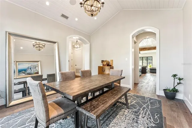 a dining room with furniture and wooden floor