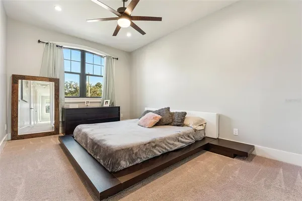 a bedroom with a bed and a painting on the wall