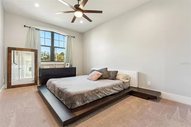 a bedroom with a bed and a painting on the wall