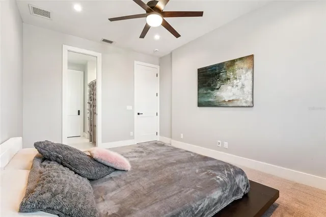 a en suite bathroom with a granite countertop tub sink and mirror