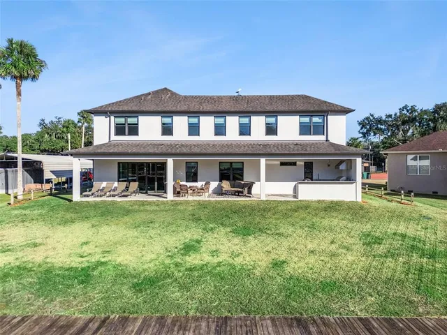an aerial view of a house with garden space ocean swimming pool and outdoor seating