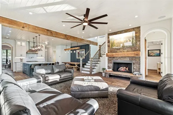 a sitting area with wooden floor and furniture