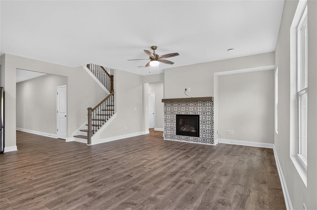 107 Ledgemont Way Acworth, GA 30101 - Photo 15 of 57 wooden floor fireplace and windows in an empty room