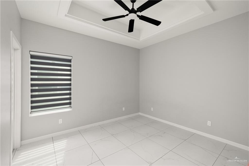 904 Deluxe Street Alamo, TX 78516 - Photo 8 of 11 Spare room with a tray ceiling and a ceiling fan