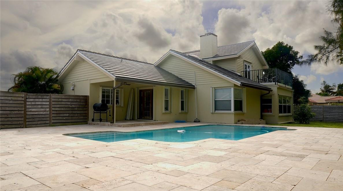 9421 Old Pine Road Boca Raton, FL 33428 - Photo 31 of 42 a front view of a house with a yard and potted plants