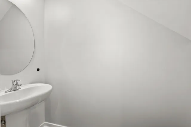 a bathroom with a sink and mirror